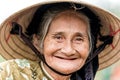 Old friendly woman with vietnamese straw hat