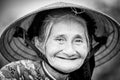 Old friendly woman with vietnamese straw hat