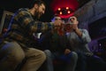 Old friends meeting. Happy young men in casual wear toasting with beer while sitting in beer pub together Royalty Free Stock Photo