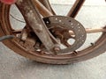 Old front disc brake motorcycle at frame on cement flooring closeup. Royalty Free Stock Photo