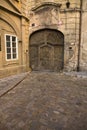 An ornate, ancient wooden door in a historic Prague alley. Royalty Free Stock Photo