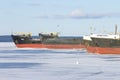 Old frozen cargo ships in the port on Onega lake in winter Royalty Free Stock Photo