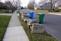 Old furniture left out near the curb near trash cans waiting to be disposed of