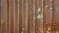 old galvanized corrugated metal sheet wall with rust used as background in close up view. rusty iron metal construction site wall Royalty Free Stock Photo