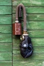 Old gas mask with coal filter hung on green wooden door handle. Concept - Nuclear Disarmament and Radiation Protection, epidemic,