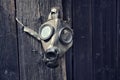 Old gas mask on wooden background, terrorism pollution apocalypse concept Royalty Free Stock Photo