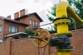 Old gas pipe gate on the background of the house Royalty Free Stock Photo