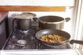 Old gas stove, with old frying pan and pans.cooking chickpeas.Old-fashioned concept