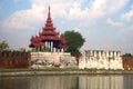 The old gate with a bastion in the old city on a cloudy evening. Mandalay, Burma