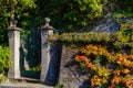 An old gate covered with multicolored wild grapes in a stone house on a street in Varenna, a small town on lake Como, Italy Royalty Free Stock Photo