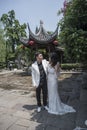 Young couple taking wedding photos in scenic area