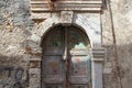 old gate with a sculpted stone arc and wood doors in rethymno in crete (greece)