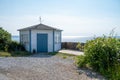 An old gazebo painted white and blue stands by the ocean in the small fishing village BarsebÃÂ¤ckshamn in southern Sweden