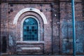 Old glass arch window in a brick wall building Royalty Free Stock Photo