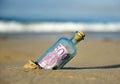 Old glass bottle with 500 euro banknote inside, sand of the beach Royalty Free Stock Photo