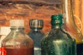 Old glass bottles with technical fluids in workshop