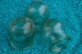 Three old glass medical jars on blue sand Royalty Free Stock Photo