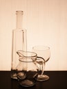 Old glassware silhouetted, tinged brown antique effect. Royalty Free Stock Photo