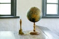 An old globe lying on a table  against the background class room. Retro style. Science, education, travel, vintage background Royalty Free Stock Photo