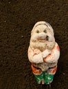 Old gnome on fine tilth soil background