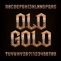 Old gold alphabet font. Ornate golden letters and numbers with diamonds. Royalty Free Stock Photo