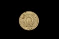 An old, gold coin from Yugoslavia isolated on a black background Royalty Free Stock Photo