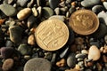 Old gold coins on stones. Royalty Free Stock Photo