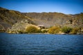 Old gold miners' shack on the shore of the Clutha River in New Zealand