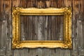 Old Gold Picture Frame on wood background, white inside mockup Royalty Free Stock Photo