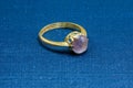 An old gold ring with amethyst on a blue mat, in shallow focus Royalty Free Stock Photo