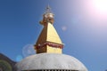 Old golden Buddhist stupa in Nepal with blue sky in the background Royalty Free Stock Photo