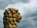 old golden lion statue in profile decorating the historic rochdale town hall against a dramatic sky