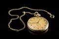 Old golden pocket watch on a black reflective surface Royalty Free Stock Photo