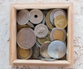 Pile of gold and silber coins in wood box on the natural background Royalty Free Stock Photo