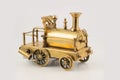 Old golden toy steam locomotive on isolated background Royalty Free Stock Photo