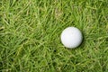 Old golf ball on green grass Royalty Free Stock Photo