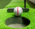 Old golf balls and putter on artificial grass Royalty Free Stock Photo