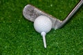 Old golf club on the tee off ready to hit the ball Royalty Free Stock Photo
