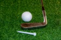 Old golf club on the tee off ready to hit the ball Royalty Free Stock Photo