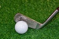 Old golf club on the tee off ready to hit the ball Royalty Free Stock Photo