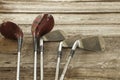 Old golf clubs on rough wood surface Royalty Free Stock Photo