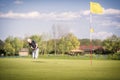 Old golf player pitching onto green. Royalty Free Stock Photo