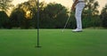 Old golf sportsman playing game on green course. Golfer enjoy summer sunset. Royalty Free Stock Photo