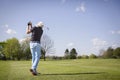 Old golfer shooting on green. Royalty Free Stock Photo