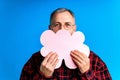 old good looking man making important life choices with paper card in cloud shade blue backgrond studio Royalty Free Stock Photo