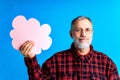 old good looking man making important life choices with paper card in cloud shade blue backgrond studio Royalty Free Stock Photo