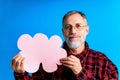 old good looking man making important life choices with paper card in cloud shade blue backgrond studio Royalty Free Stock Photo