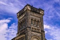Old gothic tower in front of cloudy blue sky Royalty Free Stock Photo