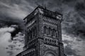 Old gothic tower in front of cloudy blue sky Royalty Free Stock Photo