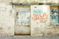 Old graffiti wall with metal door and window. Royalty Free Stock Photo